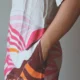 Beige Linen Botanical Print Dress with Pockets | Pocket Dress Woman wearing beige linen dress with bold pink, orange, and maroon botanical print and invisible side pockets, Pocket Dress India