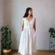 Ivory V-Neck Midi Dress with Pockets | Pocket Dress Woman wearing ivory V-neck midi dress with button accents and invisible side pockets, Pocket Dress India