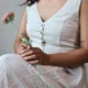Ivory V-Neck Midi Dress with Pockets | Pocket Dress Woman wearing ivory V-neck midi dress with button accents and invisible side pockets, Pocket Dress India