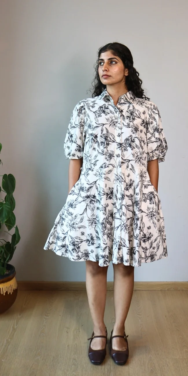 Woman wearing black and white botanical print shirt dress with puff sleeves and invisible side pockets, Pocket Dress India