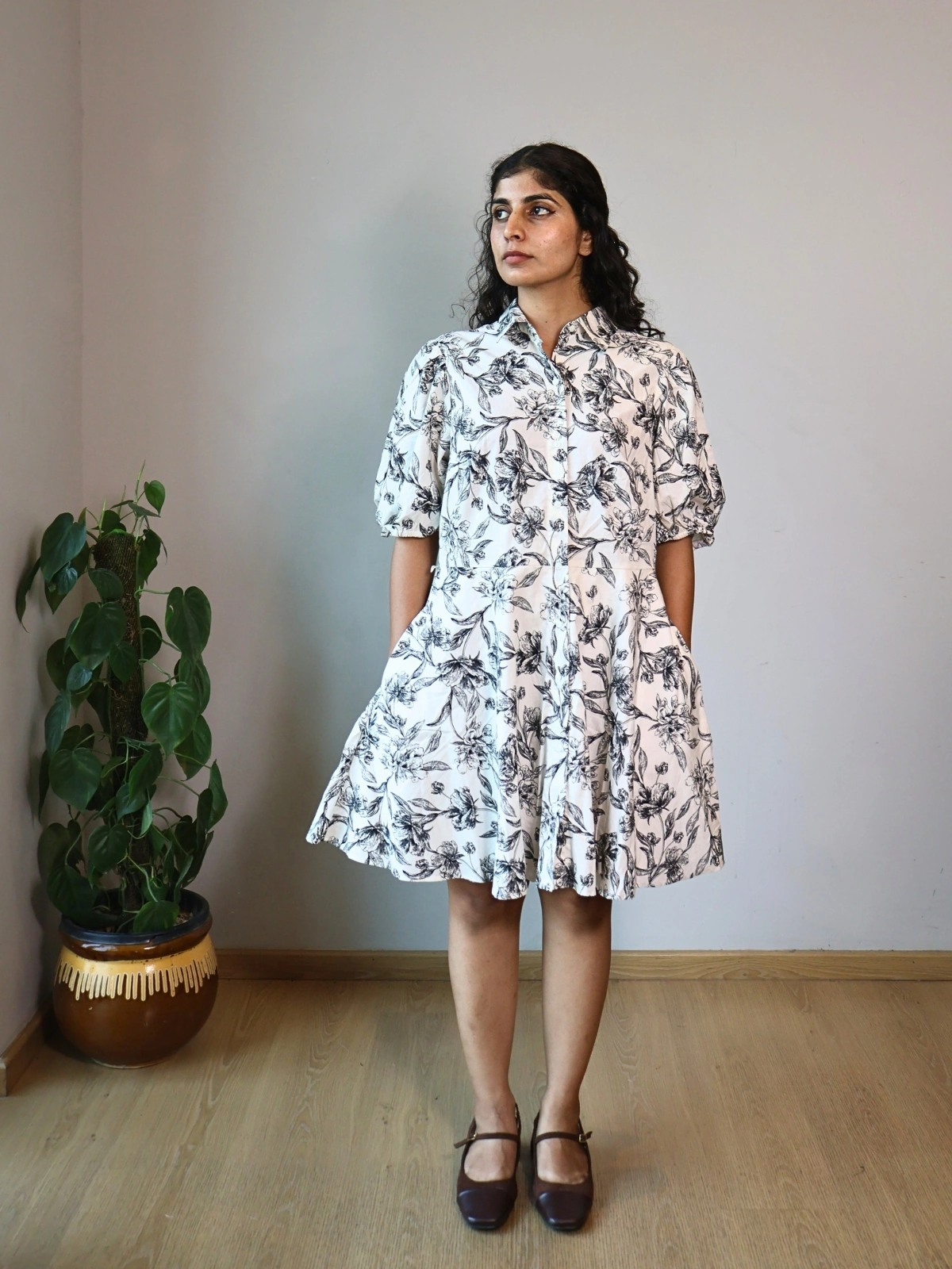 Woman wearing black and white botanical print shirt dress with puff sleeves and invisible side pockets, Pocket Dress India