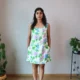 Pastel Floral Mini Dress with Pockets | Pocket Dress Woman wearing white A-line mini dress with lavender, sky blue, and green floral print and invisible side pockets, Pocket Dress India