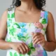 Pastel Floral Mini Dress with Pockets | Pocket Dress Woman wearing white A-line mini dress with lavender, sky blue, and green floral print and invisible side pockets, Pocket Dress India